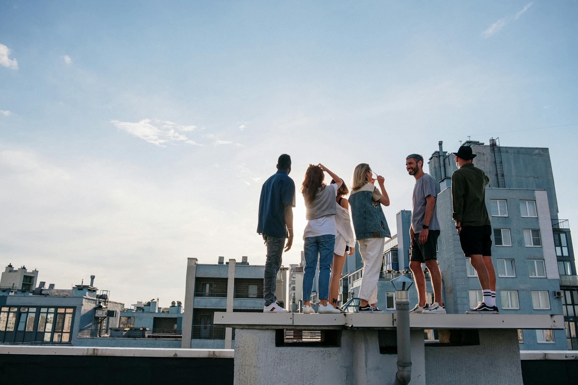 group of people standing on top of building